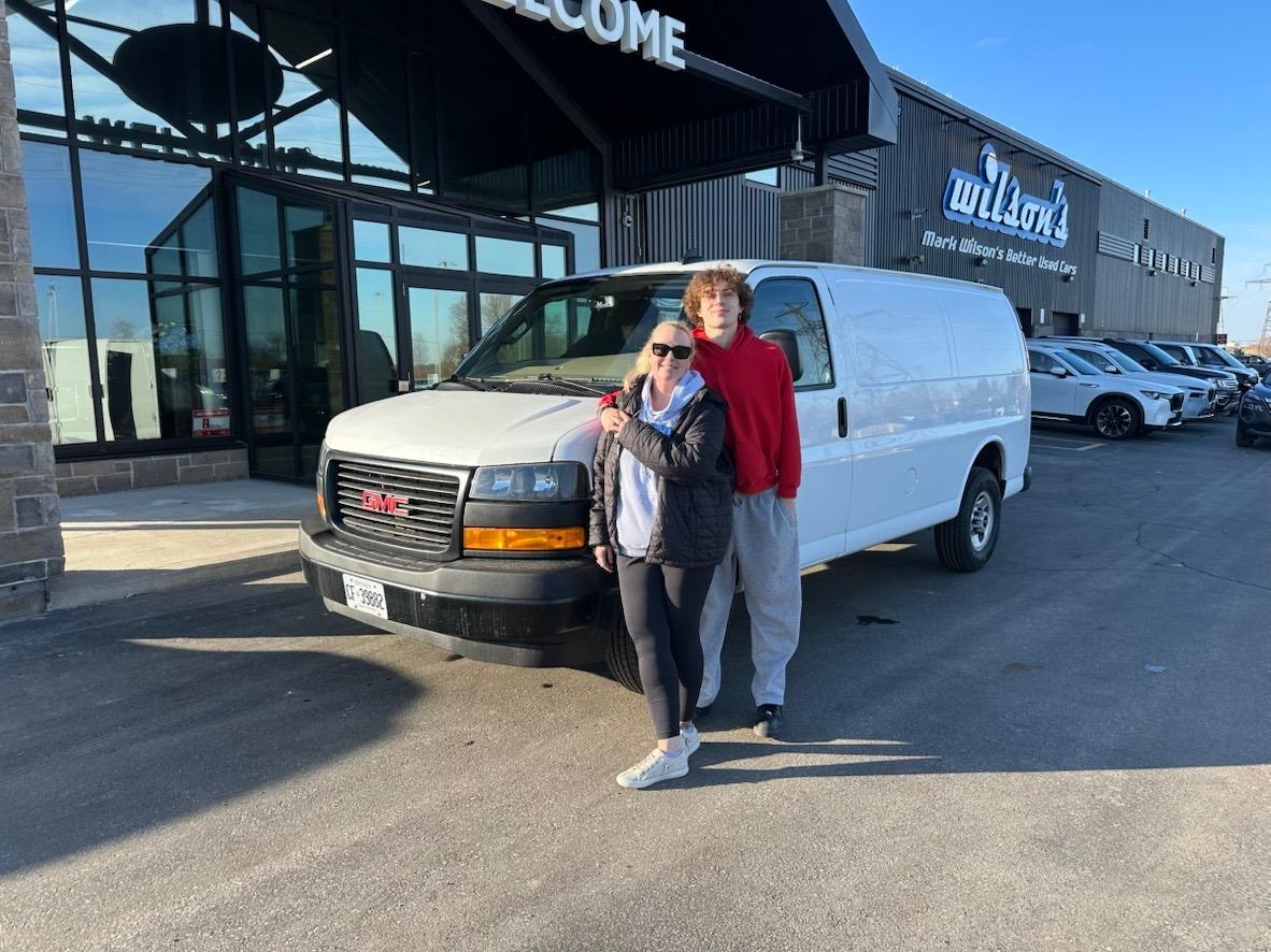 The Jojo's Junk Removal team with their GMC Savana 2500 junk removal van